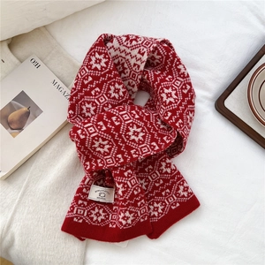 Detail of red and cream wool scarf featuring classic jacquard snowflake knit patterns