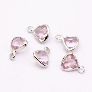 Detail of pink faceted crystal charms with silver metal frame for DIY jewelry making