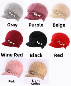 Detail view of winter knitted beret hats with rabbit fur trim and pearl flower accents