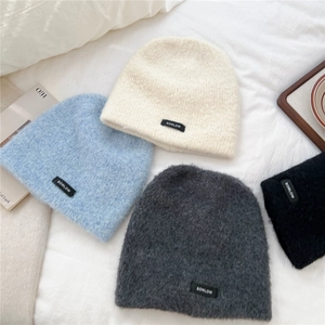 Thick warm knitted beanies for women in cream, blue, grey, and black colors
