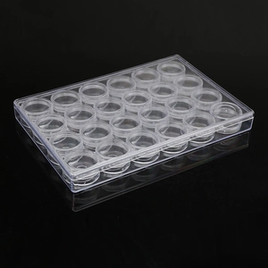 Travel set with 30 small round clear cream jars inside a rectangular storage box