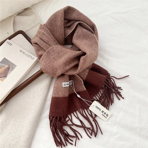 Close-up of 100% lamb wool scarf with classic herringbone pattern and soft fringe tassels