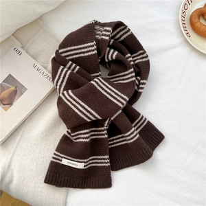 Detail view of the 100% wool material label on a striped knitted winter scarf