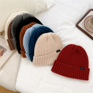 Wool knit beanies in multiple colors including beige, grey and black for winter warmth