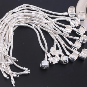 Detailed close-up of S925 silver snake chain bracelets with barrel clasp on black background