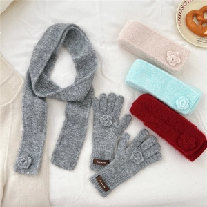 Detailed view of knitted winter scarf with handcrafted 3D flower and soft texture