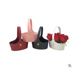 Four colorful envelope flower boxes in leather material featuring red roses in a white box