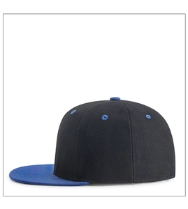 Detail of a two-tone baseball cap with black crown, blue brim and reinforced stitching
