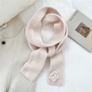 Detail of pink knitted scarf with soft floral texture and elegant rose decoration