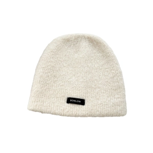 Thick cream knit beanie for women featuring a fluffy texture and black logo patch label