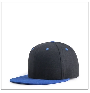 Side view of two-tone hip-hop cap featuring black body and blue flat brim with contrast eyelets