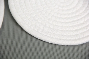 Detailed close-up of the hand-woven cotton rope texture on a round heat-resistant table mat