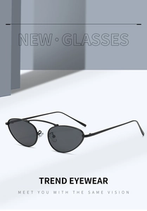 Detail showing sleek black cat-eye metal frame and dark grey lenses for a retro look