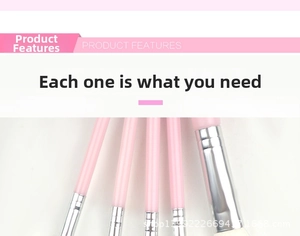 Detail view of pink makeup brushes with silver aluminum ferrules and white synthetic bristles