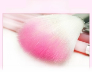 Close-up of soft pink and white gradient bristles on professional makeup brushes