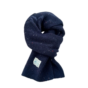 Thick navy blue knitted scarf with colorful flecks and a woven label for winter warmth