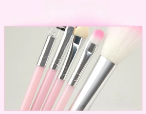 Macro detail of thickened silver metal ferrules and pink makeup brush bristles