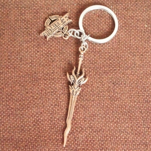Detail view of a bronze metal sword keychain with Wangzherongyao engraved charm