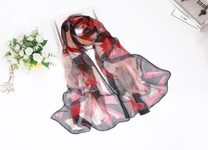 Detailed view of the thin red and black geometric pattern chiffon silk scarf fabric