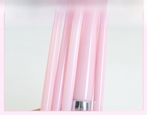 Close-up of pink makeup brush with glossy lacquer handle and silver metal ferrule