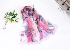 Detail of thin chiffon scarf featuring pink and blue leaf patterns with flowers