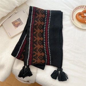 Detailed view of winter tassel scarf featuring Nordic geometric patterns and warm textures
