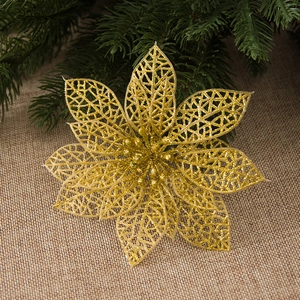 Golden hollow glitter Poinsettia flower on burlap with pine branches for Christmas decor