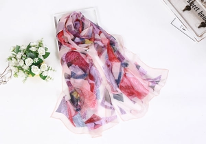 Detailed close-up of lightweight chiffon silk scarf with geometric patterns on white surface