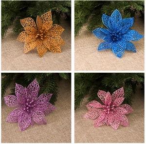 Close-up of glitter hollow Christmas flowers in gold, blue, purple, and pink colors