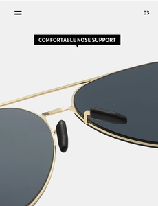 Detail of adjustable black soft silicone nose pads on gold aviator sunglasses