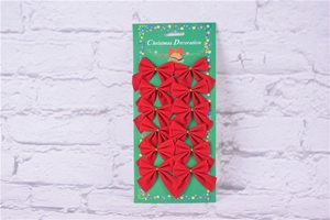 Detailed view of 12 red velvet Christmas bows displayed on a festive green card packaging