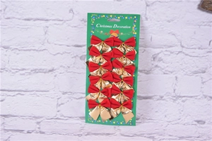 Close-up of 12 red and gold Christmas ribbon bows on a green card with brick background