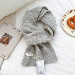 Detail of 100% wool knitted scarf showing thick texture and authentic quality tags