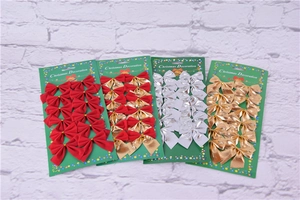 Detail view of 4-pack Christmas bows in red, gold, and silver foil for holiday decorations