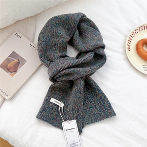 Detail of 100% pure wool scarf with mixed purple and green weave and care label