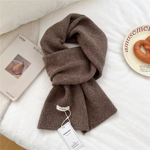 Detail of soft 100% wool chunky knit scarf in coffee brown with premium texture