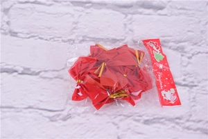 Macro detail of red flocked Christmas bows packaged in a transparent bag for tree decoration