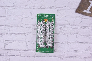 Close-up of 12 pieces of silver textured fabric Christmas bows on a green backing board
