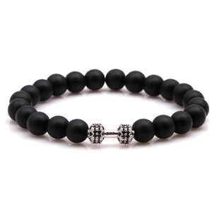 Matte black volcanic lava bead bracelet with a crystal-encrusted dumbbell charm for fitness