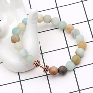 Detailed shot of matte stone beads bracelet with a rose gold dumbbell charm inlay