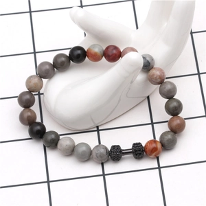 Detail of multi-color natural stone bead bracelet featuring a black micro-set dumbbell charm