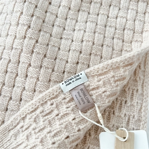 Macro shot of basket-weave knit texture on this 100% wool beige scarf detail
