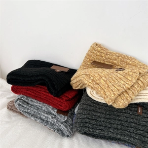 Thick ribbed knit scarves for winter shown in black, red, grey, and yellow pile