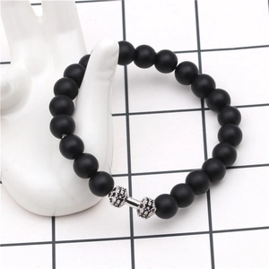 Detail of beaded dumbbell bracelet featuring matte black stones and micro-pave zircons