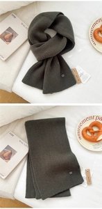 Detailed close-up showing the soft vertical knit texture of the dark grey wool scarf