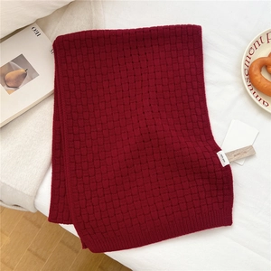Detail of dark red 100% wool scarf featuring a premium woven check texture and rib edges