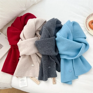 Solid color wool knit scarves set in red, beige, and blue with wood hangers