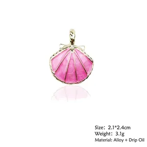 Pink enamel shell charm with gold trim detailing size 2.1x2.4cm and weight 3.1g