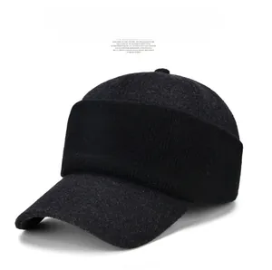 Close-up of winter peak cap with dark grey felt fabric and ribbed knit details