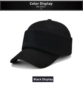 Close-up of black winter baseball cap with thick fold-over thermal ear flaps in soft wool